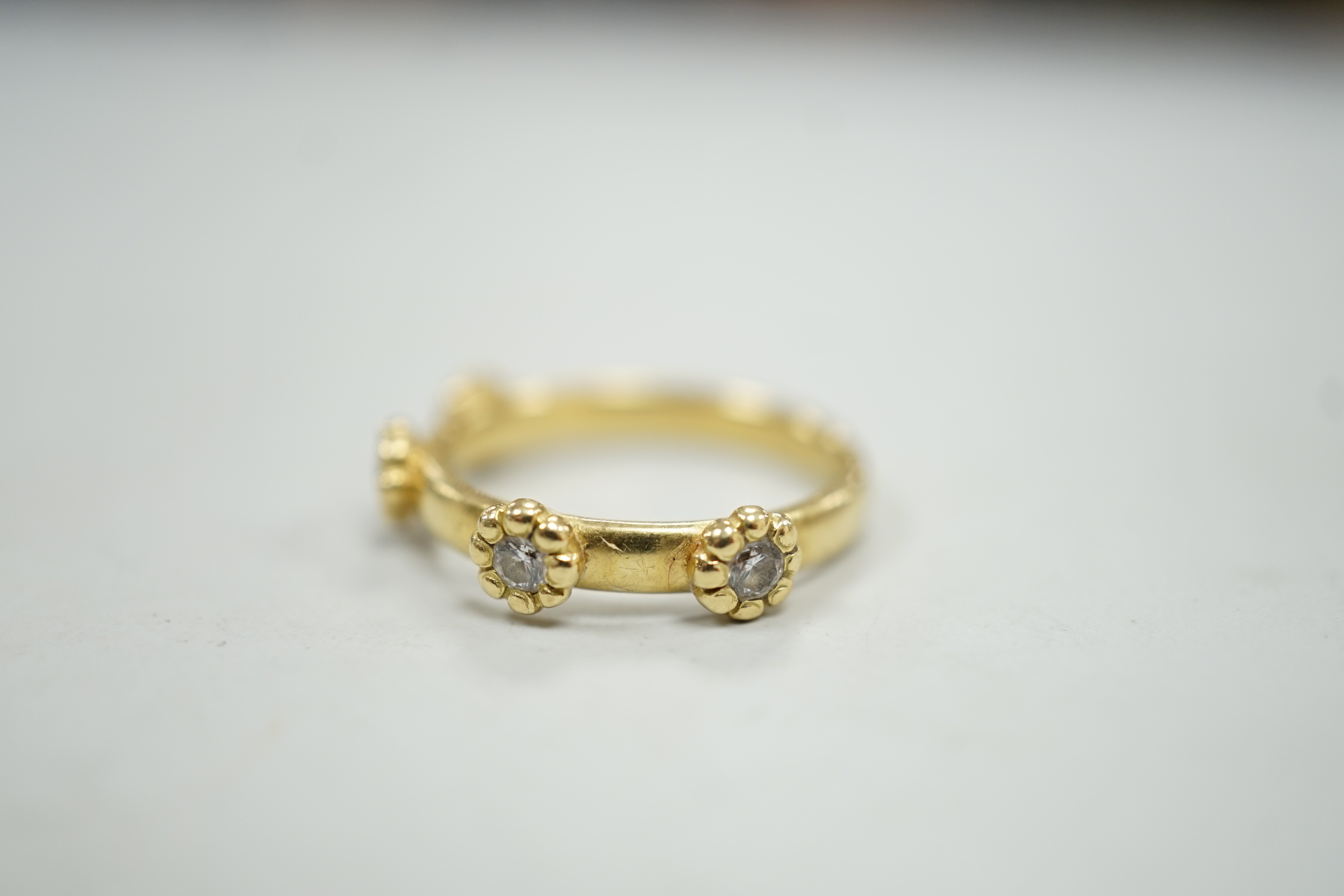 A modern 18ct gold and four stone diamond set ring, size K, gross weight 4 grams.